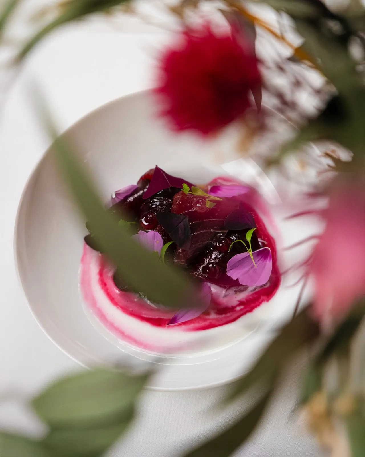 Hôtel La Ponche — a plate seen through the flowers
